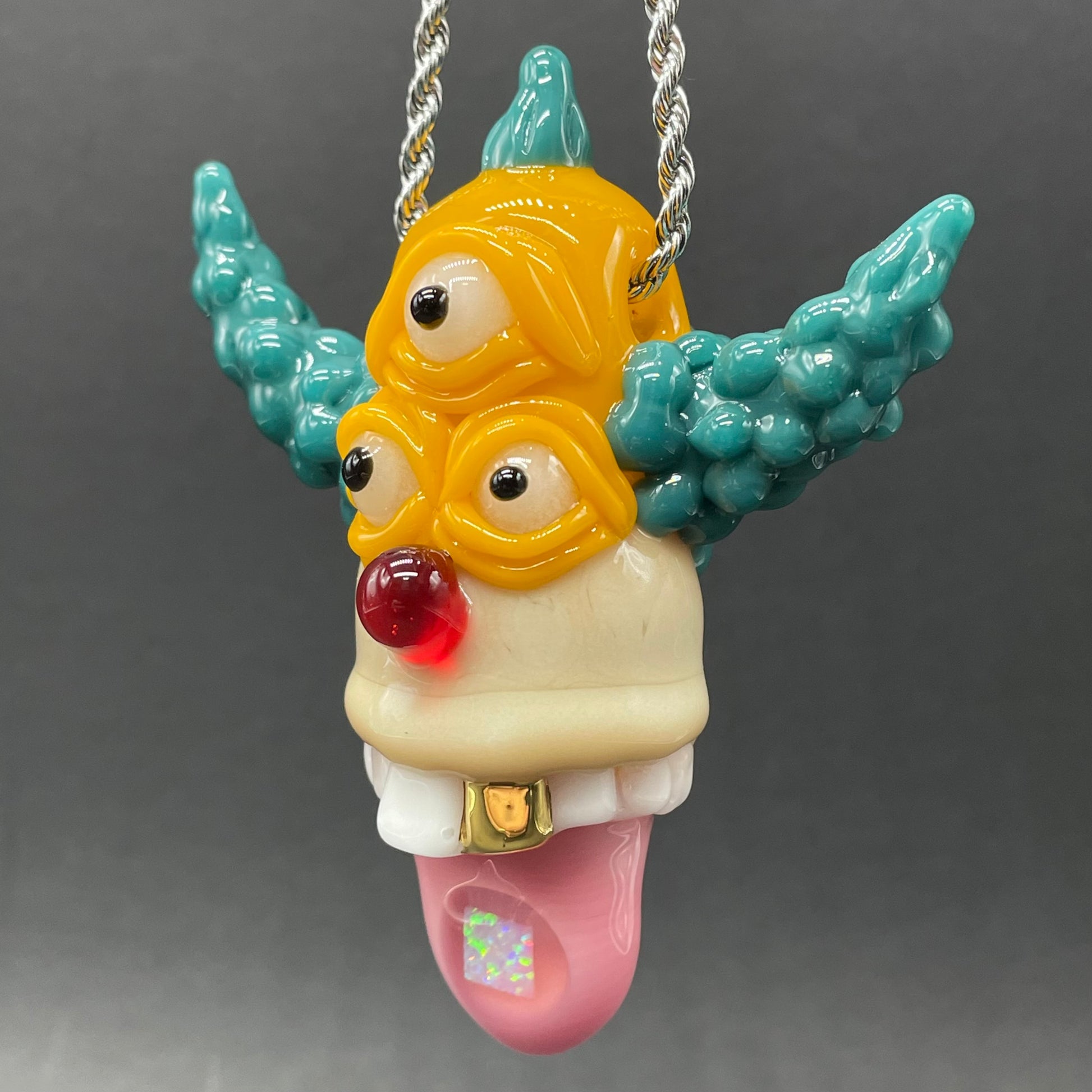 Close-up of Krusty the clown glass pendant with opal tab - handcrafted glass
