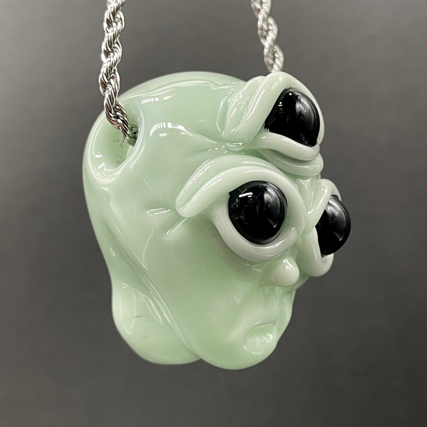 Time manipulating three eye glass alien pendant