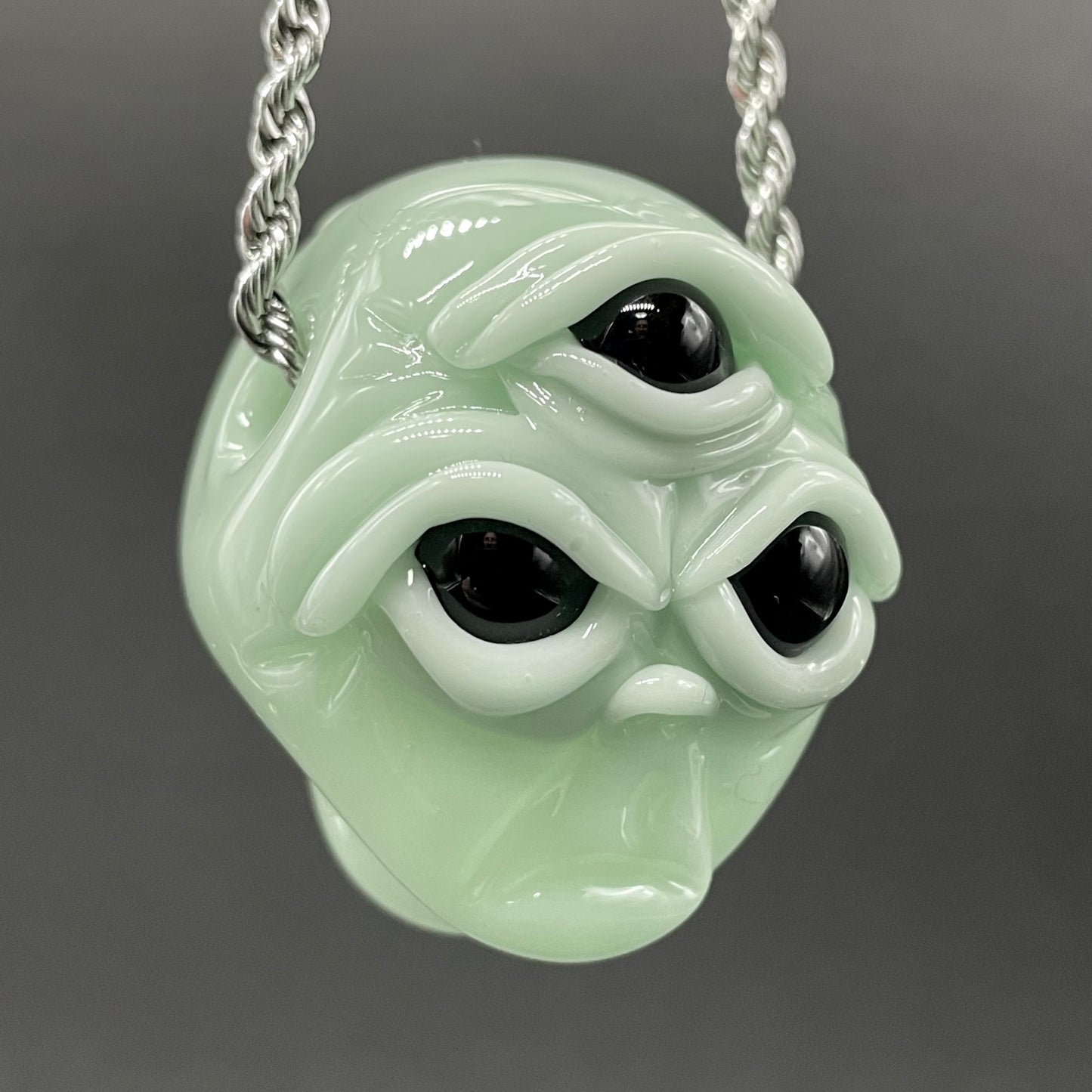 Time manipulating three eye glass alien pendant