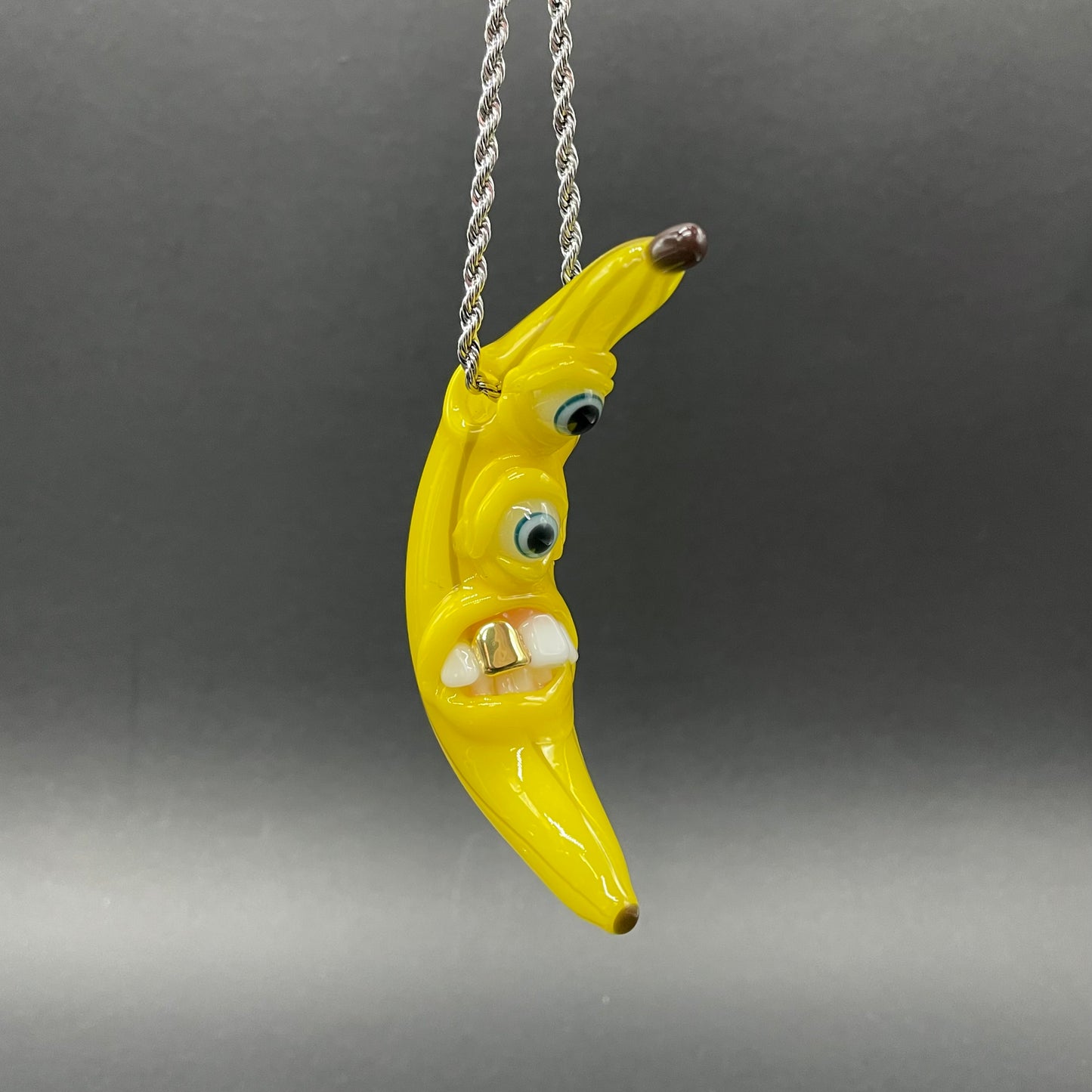 Grinning glass banana pendant