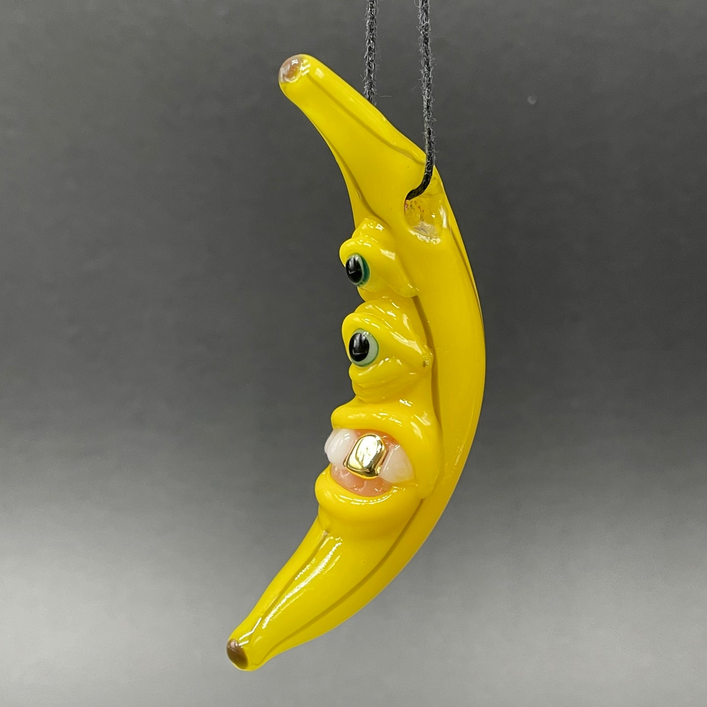 Grinning glass banana pendant