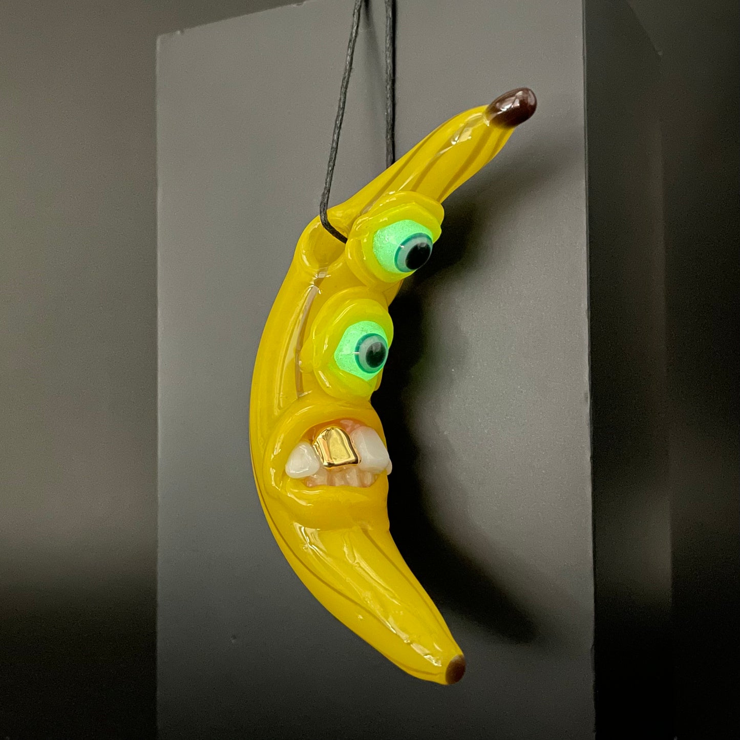 Grinning glass banana pendant