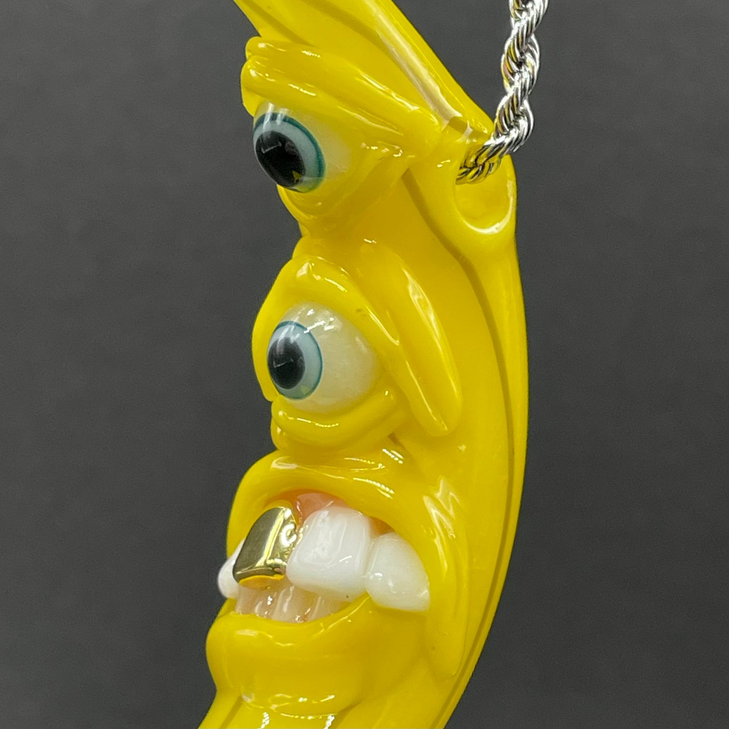 Grinning glass banana pendant