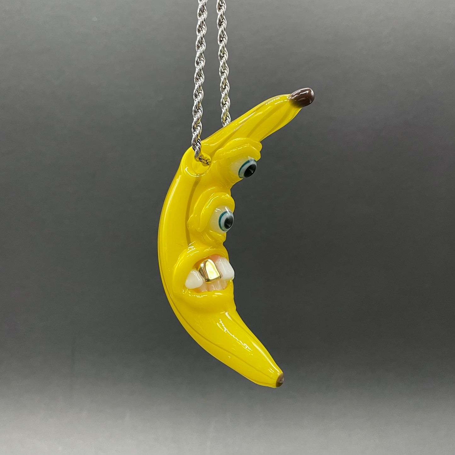 Grinning glass banana pendant